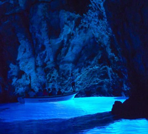 The Blue Grotto or Blue Cave, is a waterlogged sea cave located in a small bay called Balun, on the east side of the island of Biševo and about 4.5 nautical miles (8.3 km) from Komiža, in the Croatian Adriatic. It is situated in the central Dalmatian archipelago, 5 km south-west of the island of Vis. The grotto is one of the best known natural beauty spots on the Adriatic and a popular show cave because of the glowing blue light that appears at certain times of day.